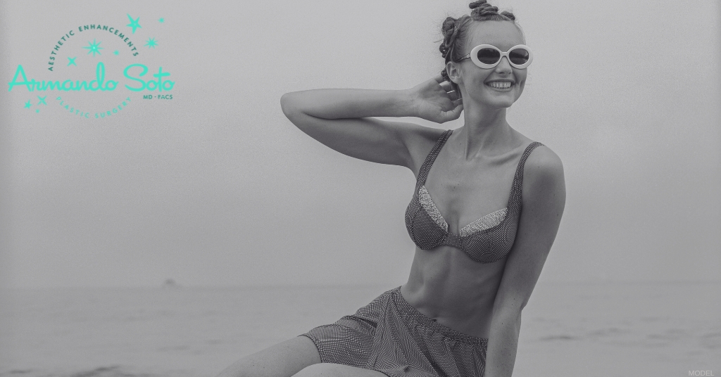 Woman sitting on a rock wearing a bikini (MODEL)